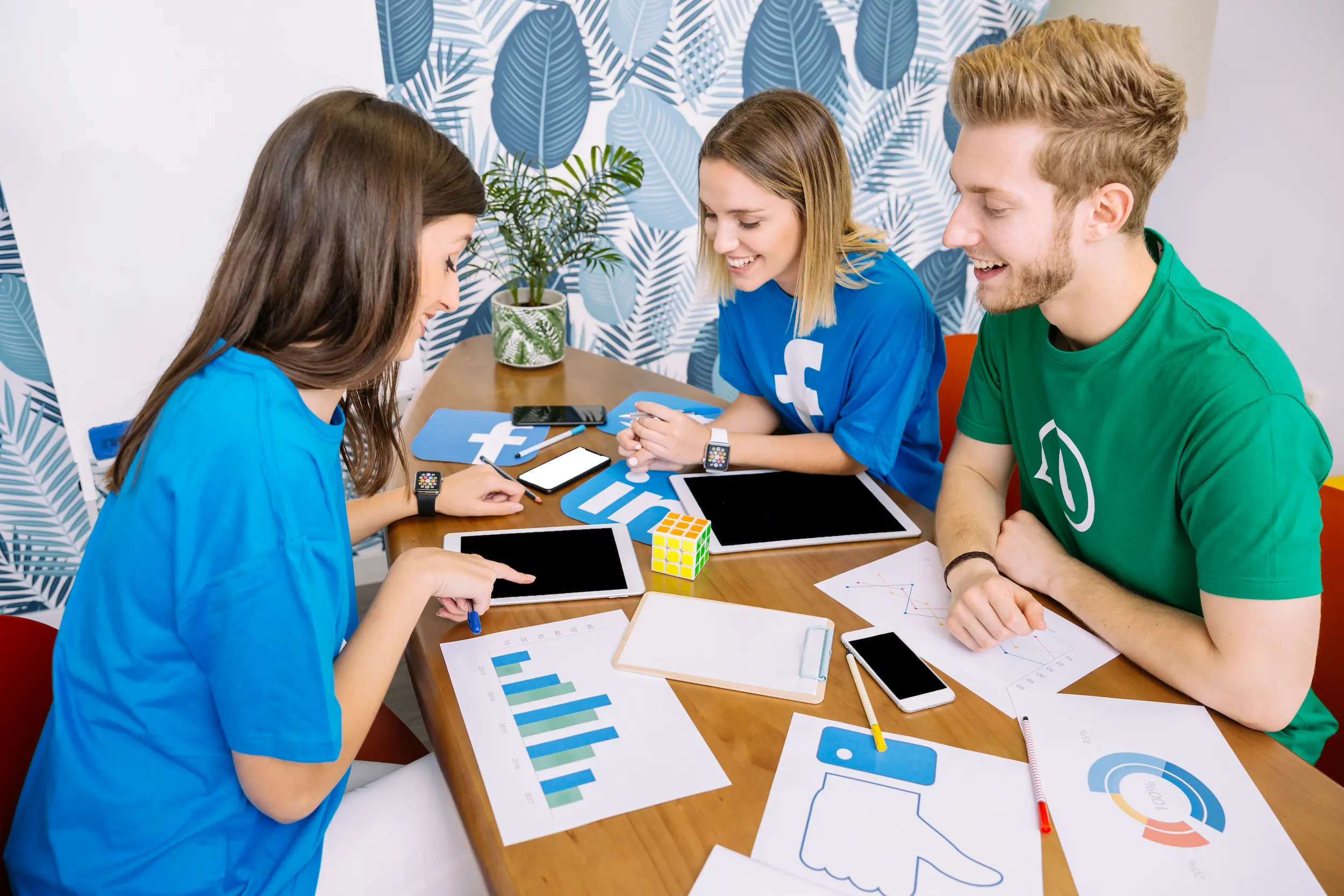 happy-social-media-team-looking-digital-tablet.webp
